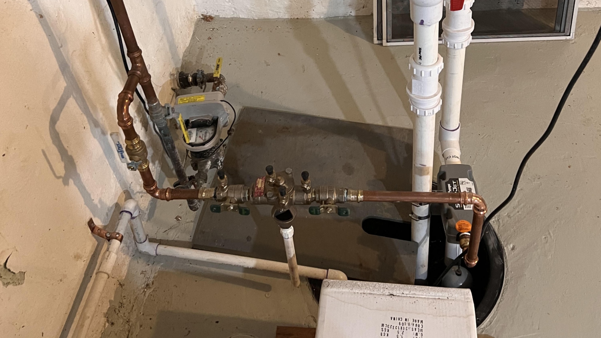 New sump pump, check valve and copper water service piping in a North Jersey basement